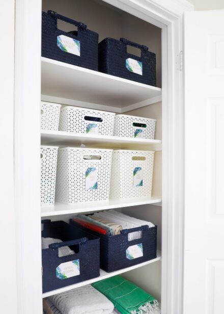 This hallway linen closet is organized to perfection.