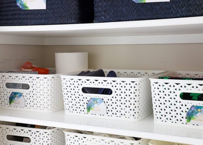 Sturdy baskets and gorgeous labels keep this linen closet organized.