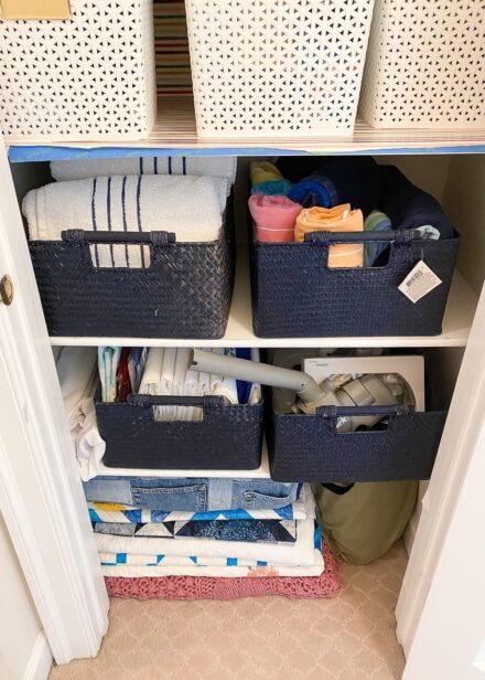 This linen closet is untidy and in need of a little extra organization.