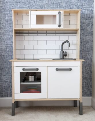An IKEA play kitchen with organized play food