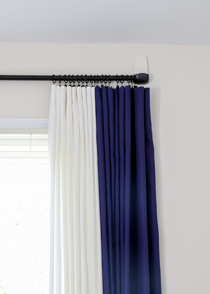 Navy and white curtains on a curtain rod put up on rental walls with Command Hooks.