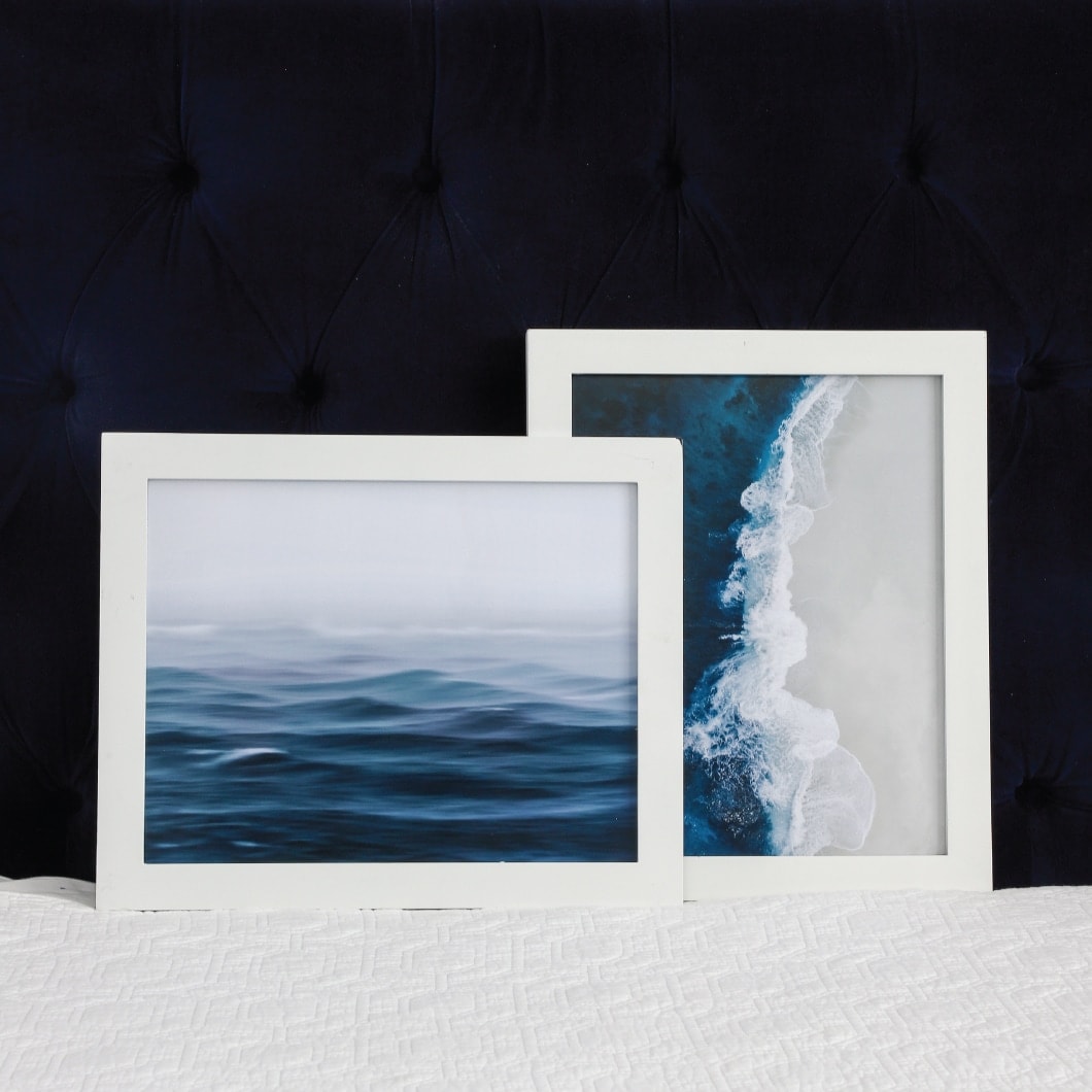 White frames with blue, white, and grey ocean artwork.