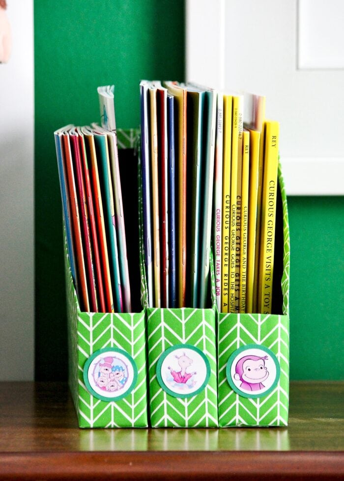 Kids books organized in DIY Book Organizers made from cereal boxes.