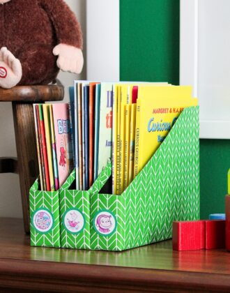 Kids books organized in DIY Book Organizers made from cereal boxes.