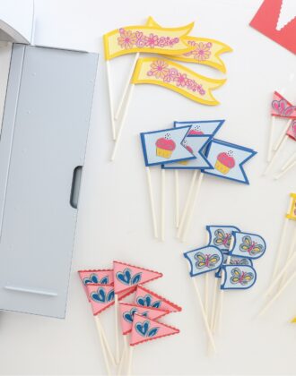 Pink blue and yellow cupcake toppers made with Cricut Smart Paper Sticker Cardstock