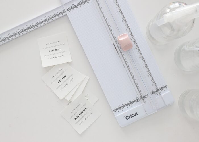 Black-and-white printable cleaning supply labels shown with a paper trimmer.