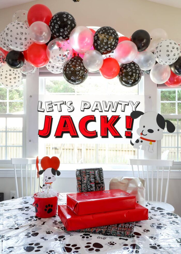 Red, black, and white puppy dog themed birthday party decorations.