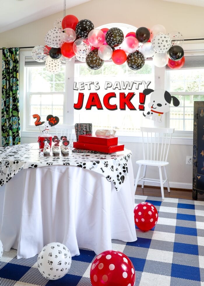 Red, black, and white puppy dog themed birthday party decorations.