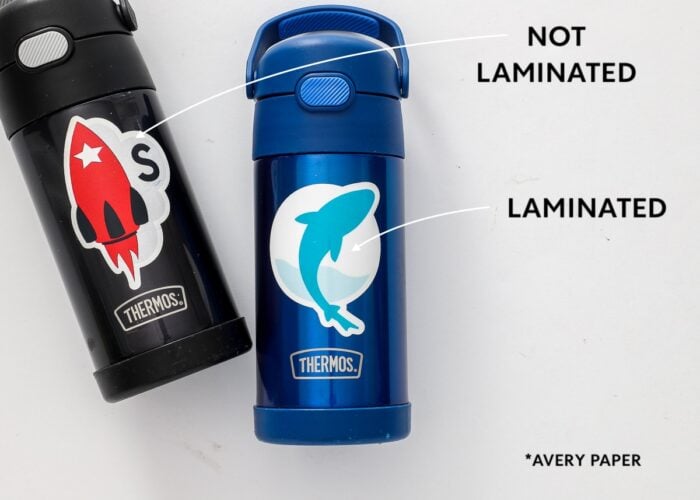 Black and blue water bottles labeled with waterproof stickers.