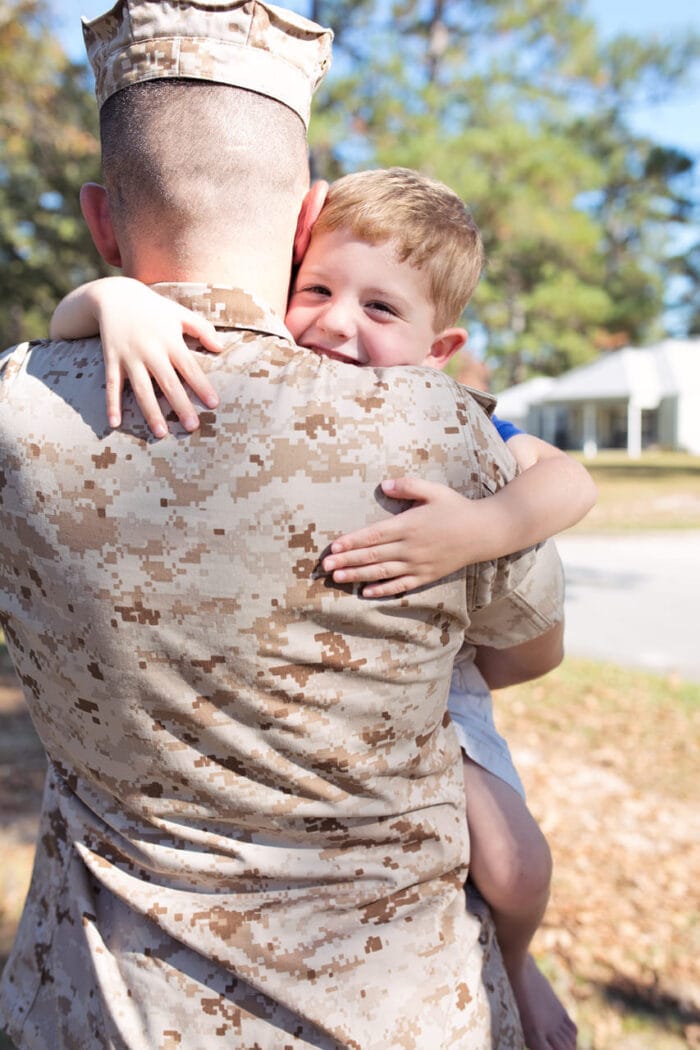 US Marine hugging a child.