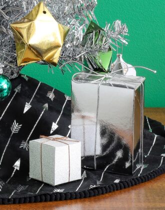 Miniature Christmas presents in silver and white.