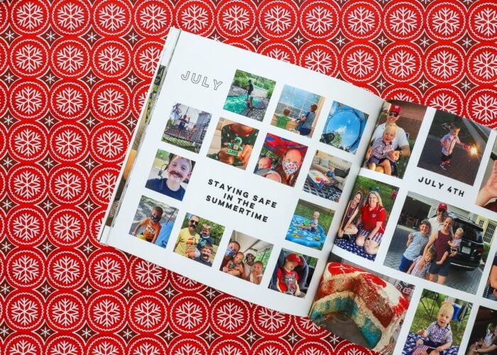 An open Family Yearbook on a red Christmas background.