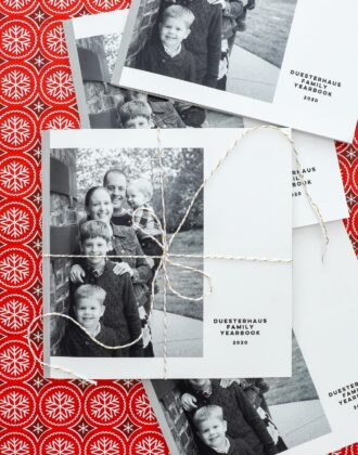 Black-and-white Family Yearbook on a red Christmas background.