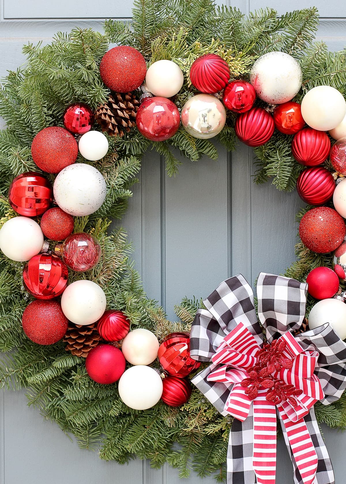 Red and white ornaments on a pine wreath