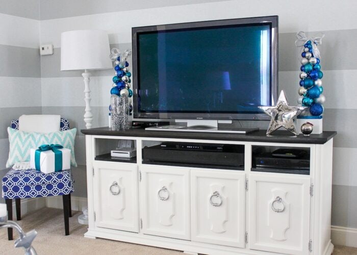Grey family room with blue, silver, turquoise, and white Christmas decorations.