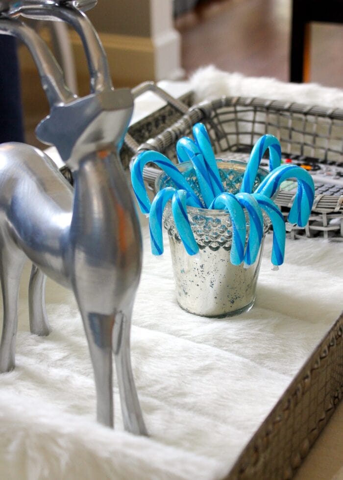 Blue candy canes next to a silver reindeer.