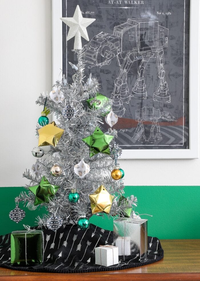 Mini Christmas tree with gold, silver, and green ornaments.