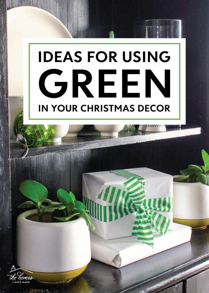 Black bookcases filled with green Christmas decorations.