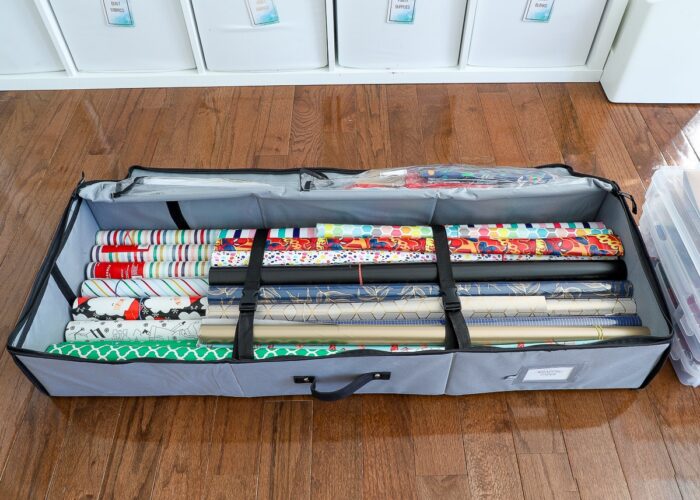 Grey wrapping paper storage tote opened on a floor