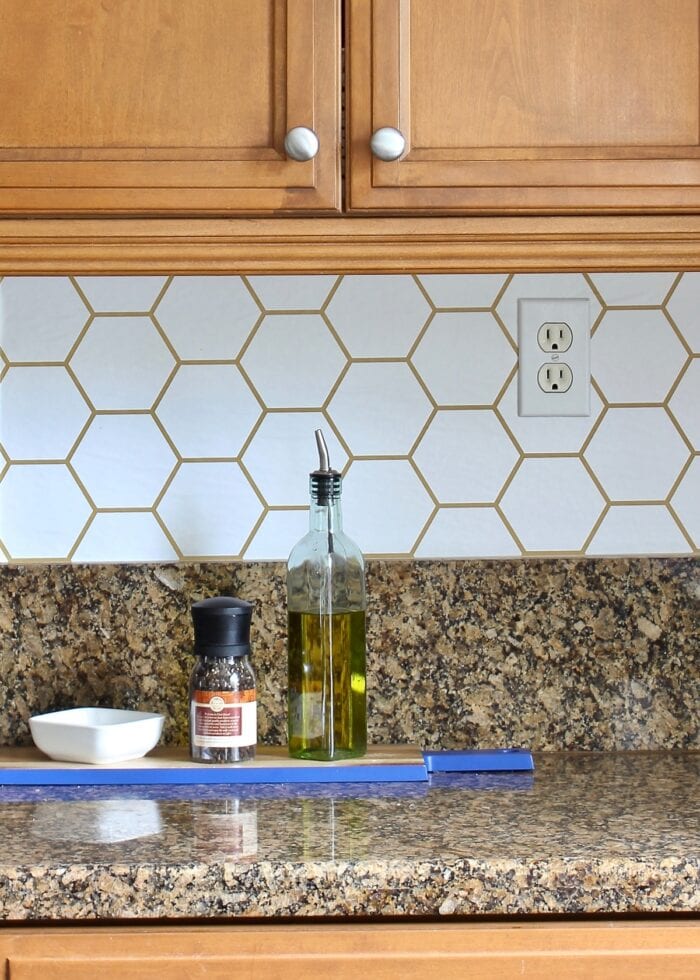 A kitchen counter with a blue tray holding cooking oil, salt, and pepper