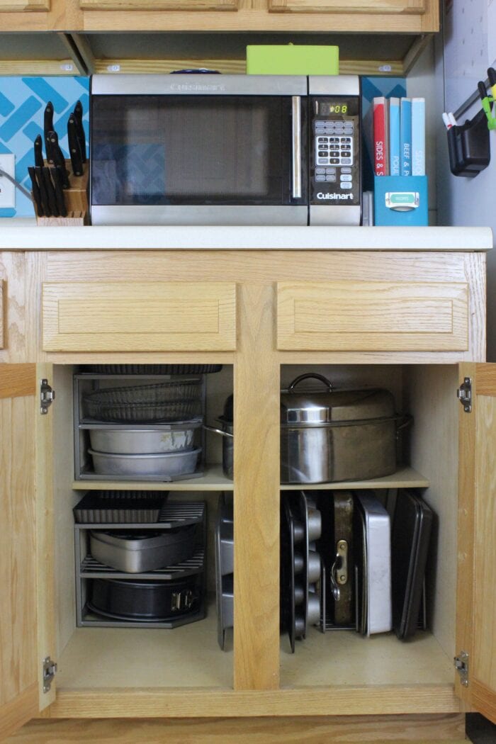 Bakeware stored in a lower kitchen cabinet