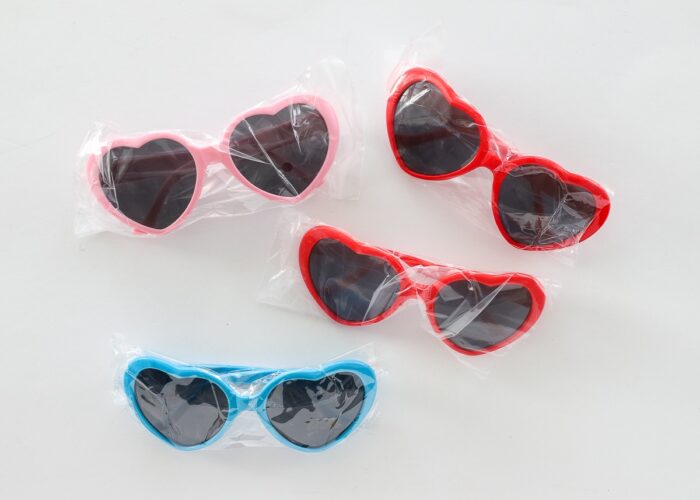Heart-shaped sunglasses in red, blue, and pink