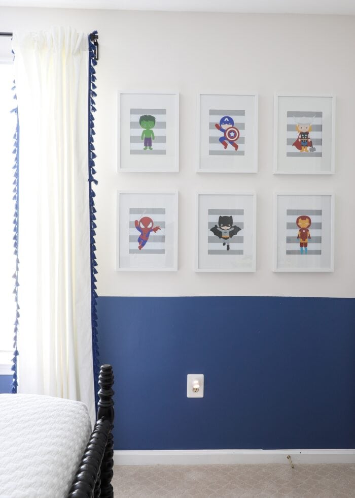 Superhero artwork on a white bedroom wall