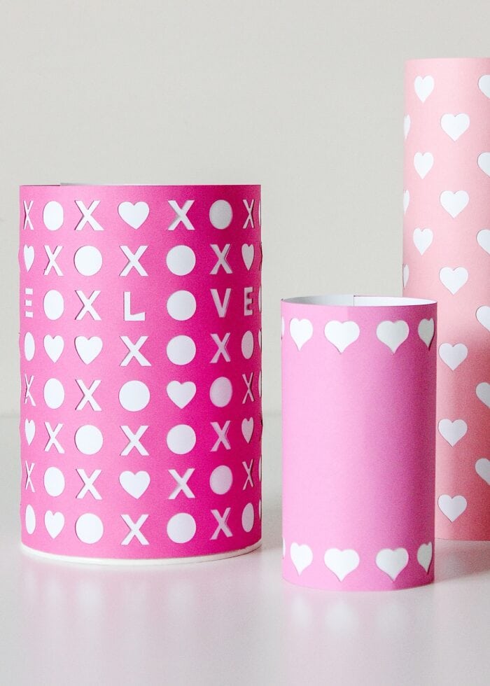 White papers on the inside of pink Valentines vases