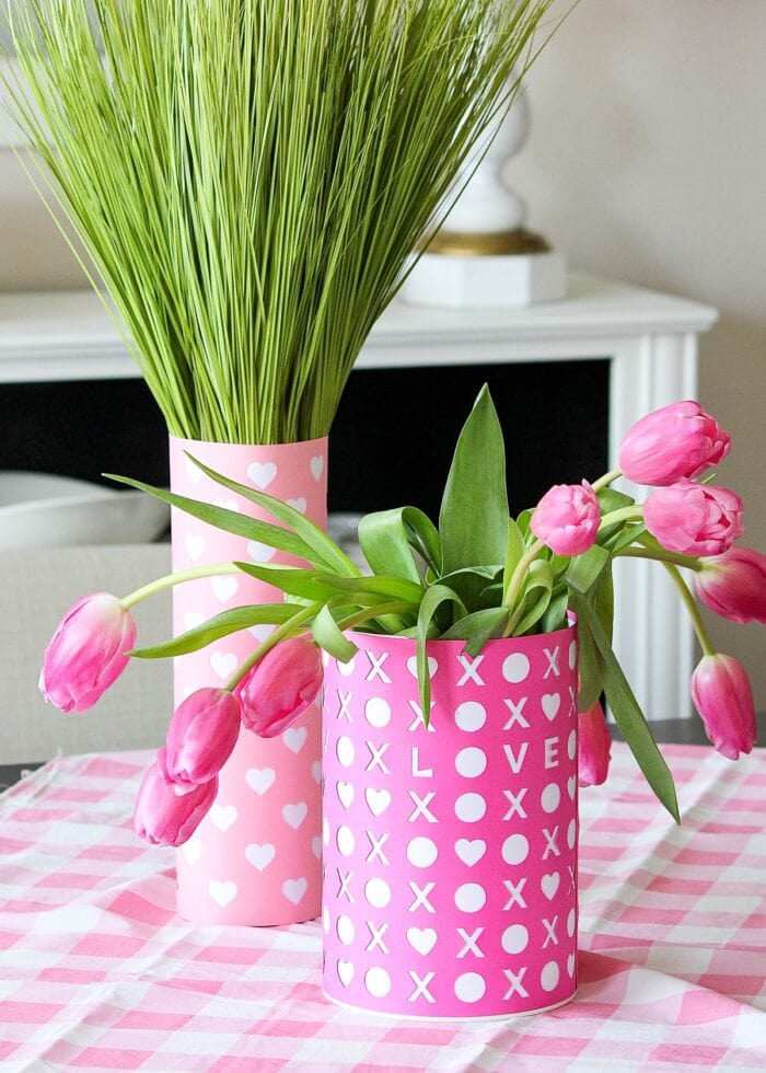 Pink Valentine's Day vase with tulips on a checkered tablecloth