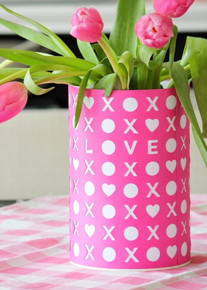 Pink Valentine's Day vase with tulips on a checkered tablecloth