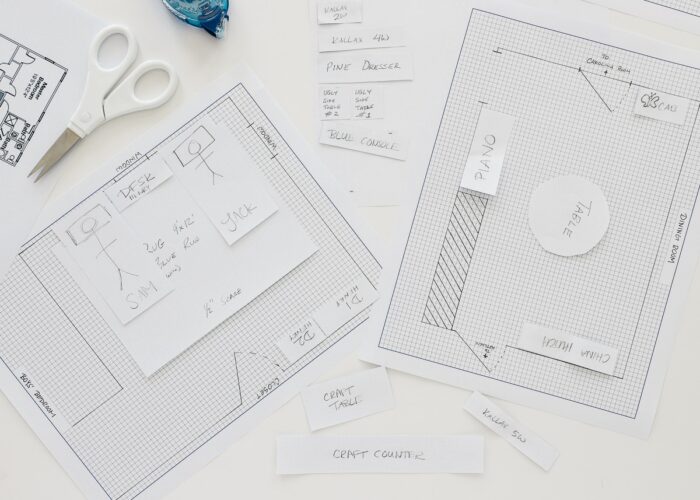 Overhead shot of a room layout drafted onto graph paper with furniture mockups
