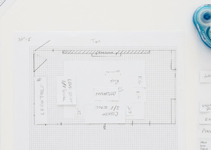 Overhead shot of a room layout drafted onto graph paper with furniture mockups