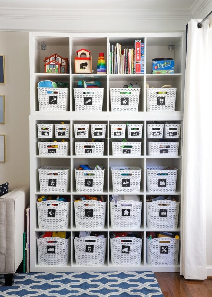 Toy Storage Ideas: IKEA Kallax Shelves in a playroom loaded with white baskets full of toys