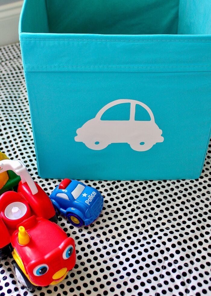 A turquoise DRONA bin holding cars