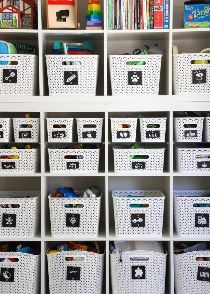 Toy Storage Ideas: IKEA Kallax Shelves in a playroom loaded with white baskets full of toys
