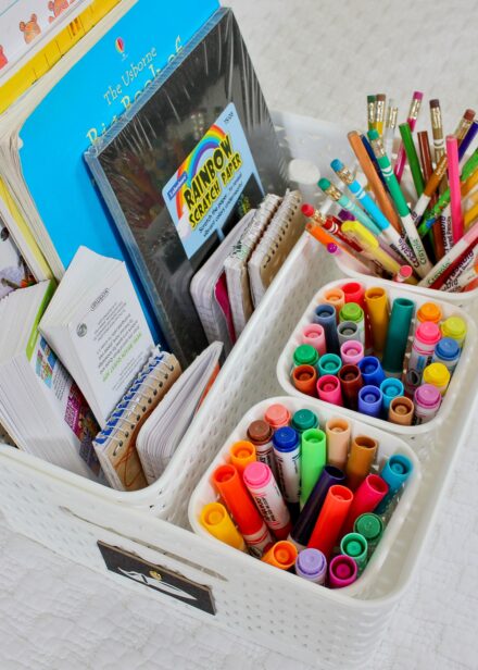 Art supplies stored in a white y-weave basket