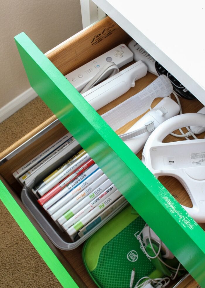 Video games and accessories stored in green drawers