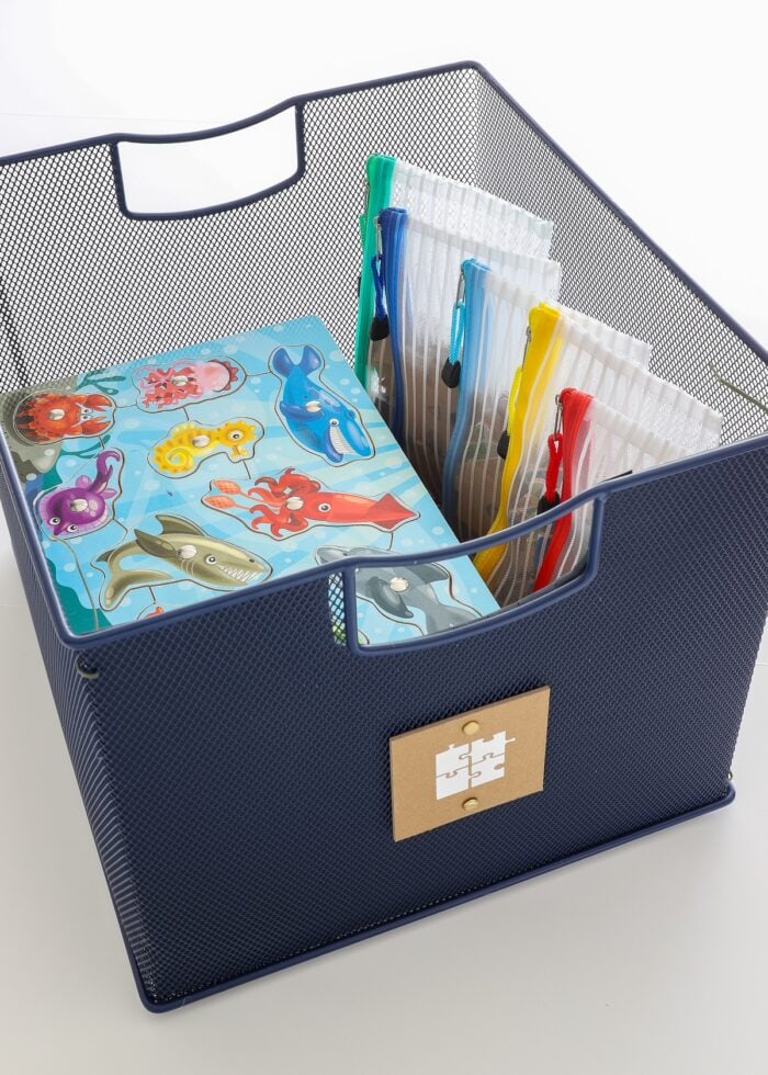 Puzzles stored in a navy blue basket