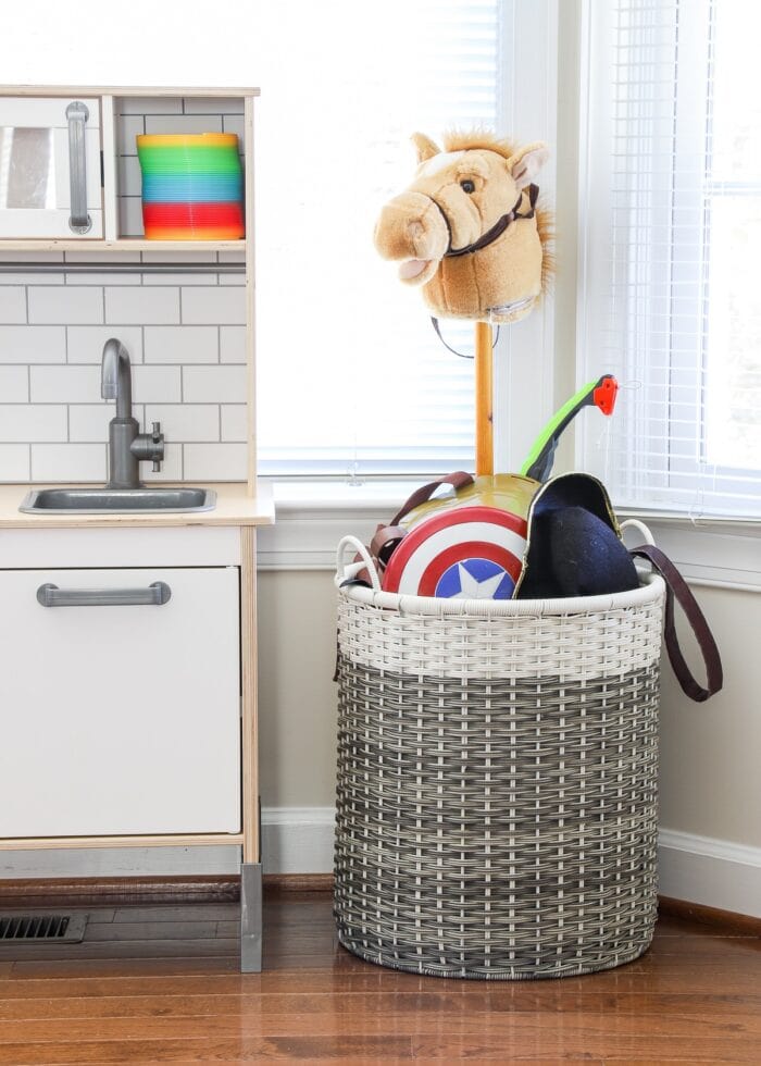 Large basket holding dress-up items in a playroom