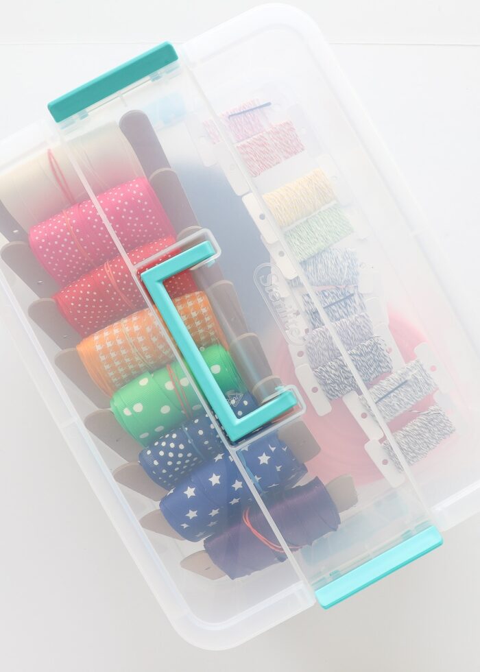 Bobbins of colorful ribbon in a clear tote