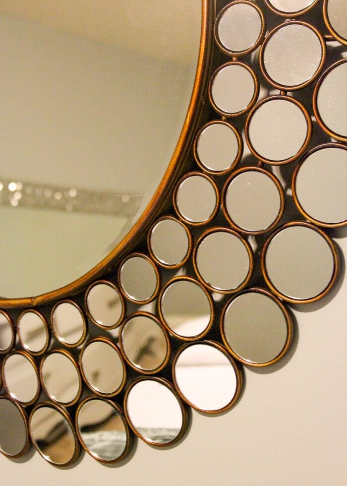 A circle wall mirror with bronze frame
