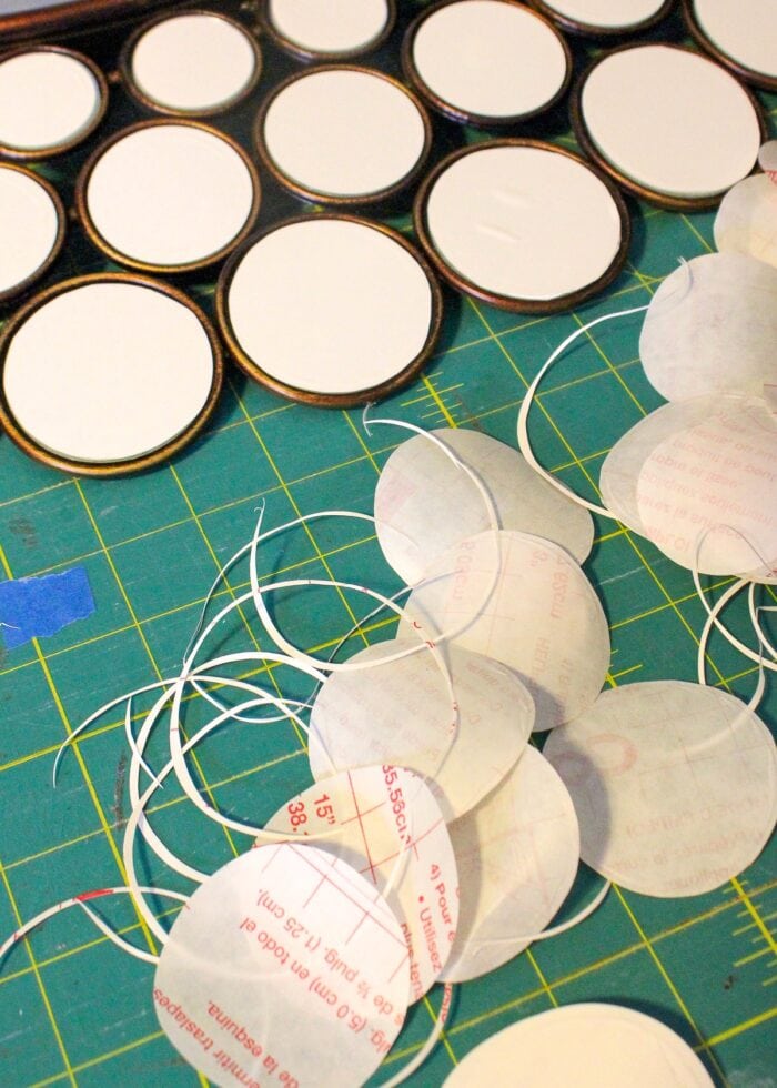 White contact paper circles on a green table