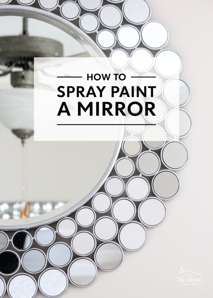 Silver spray painted mirror hung on neutral wall