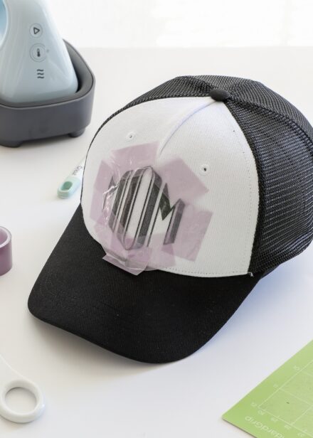 Strong Heat Resistant tape holding iron-on design to Cricut Trucker Hat