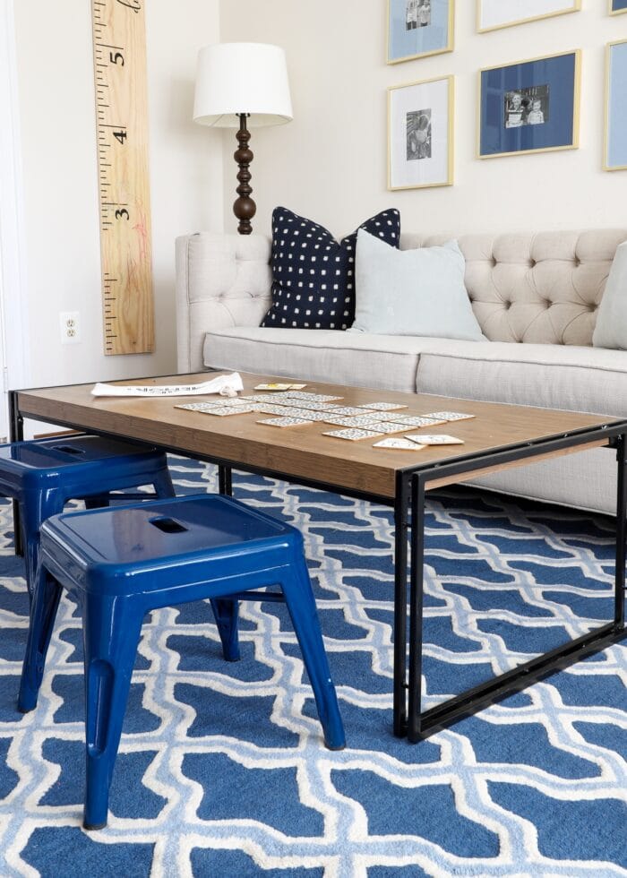 Brown coffee table in a playroom on a blue rug