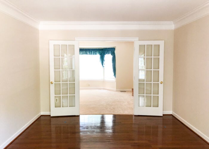 Big empty formal living room with beige walls
