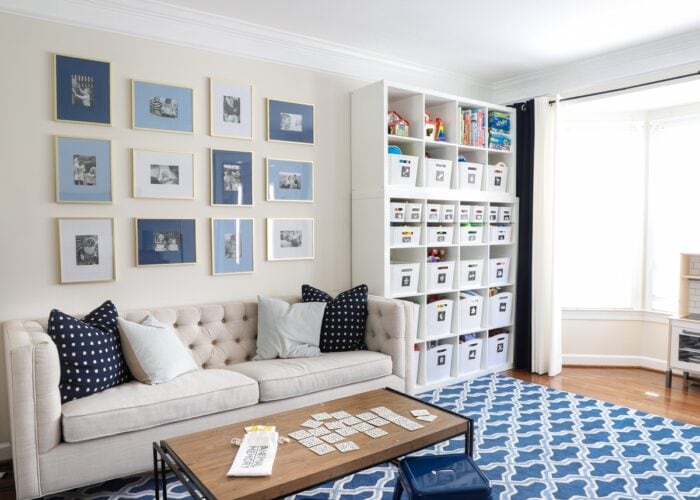 Blue and white playroom with couch and toy storage shelves