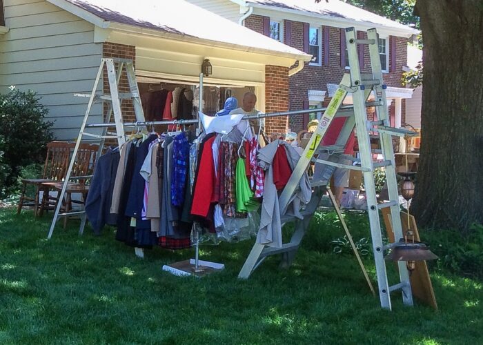Ladders and a pole used to hang clothing at a yard sale