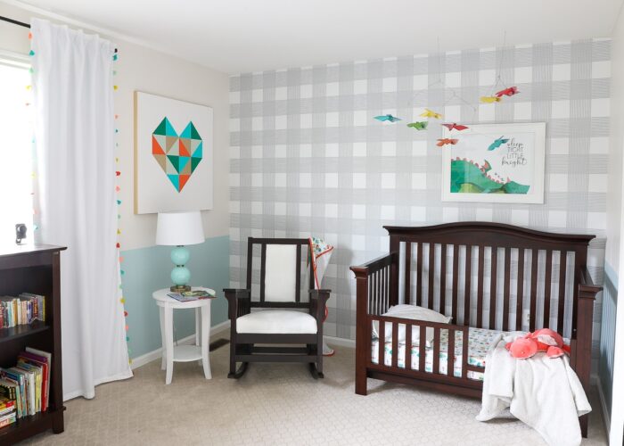 Grey and white checkered wall in a nursery with dark furniture