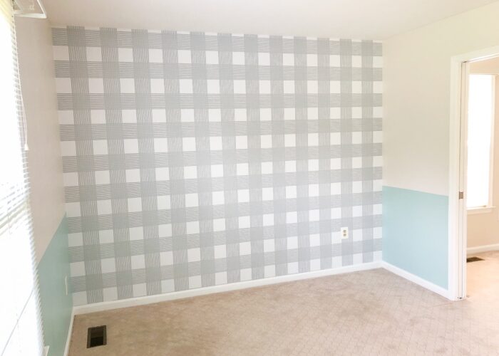 Nursery with blue half wall and grey checked wallpaper